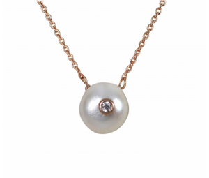 A Freshwater Keshi Pearl hangs from a gold chain and features a tiny delicate pave zirconia stone