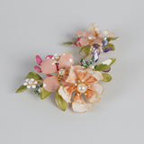 Pair of floral earrings with pearl centers and blush petals