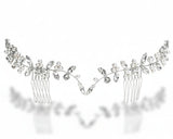 Silver hair comb with decorative elements on a white background
