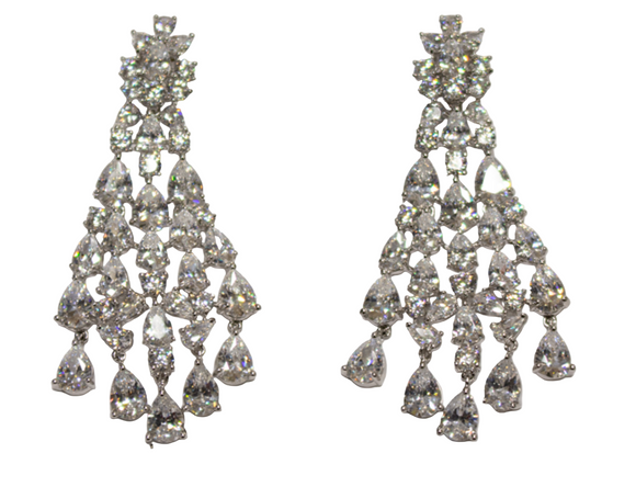 Pair of diamond chandelier earrings on a light gray background