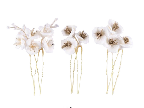 Six handmade ivory floral hairpins with gold-colored stems on a white background.