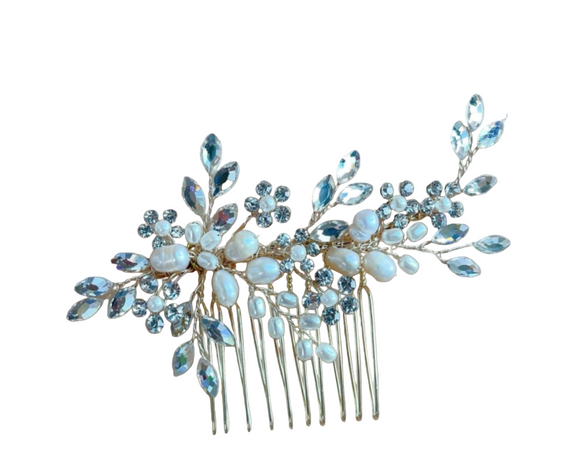 Silver hair comb with pearls and crystals on a white background