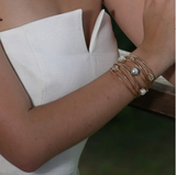 elegant 18kt gold plated demi-cuff with a collection of Moonstone, fresh water pearl, and Zirconia.